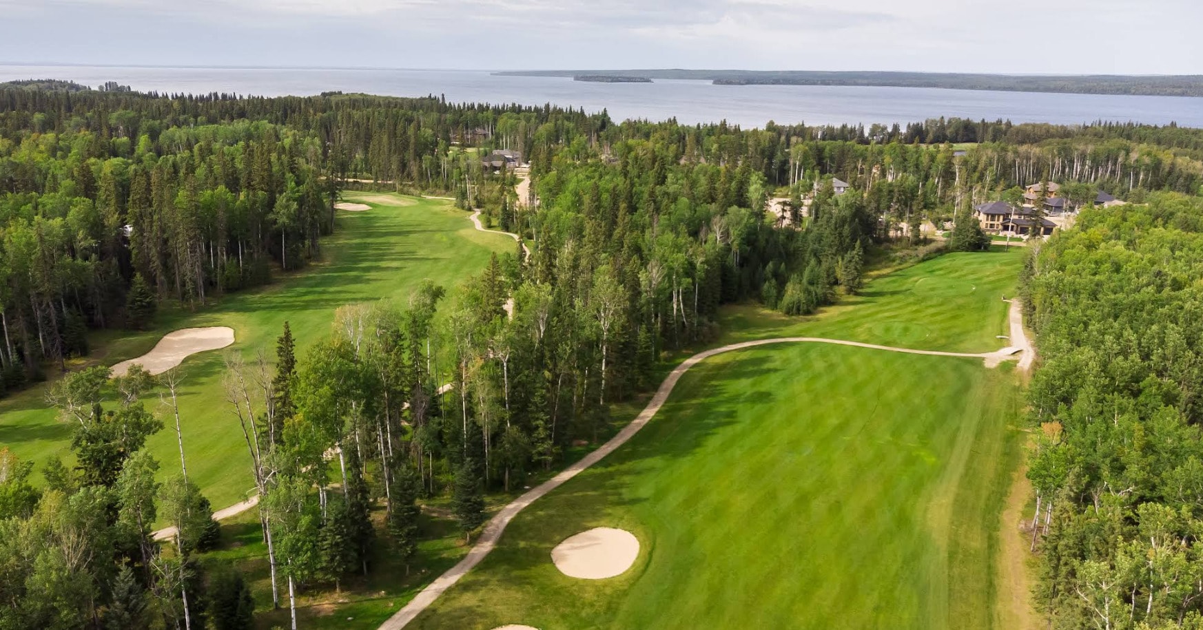 Aerial view of Candle Lake Golf Resort, where forested fairways meet the sparkling shoreline of Candle Lake. Aerial view of Candle Lake Golf Resort, where forested fairways meet the sparkling shoreline of Candle Lake.