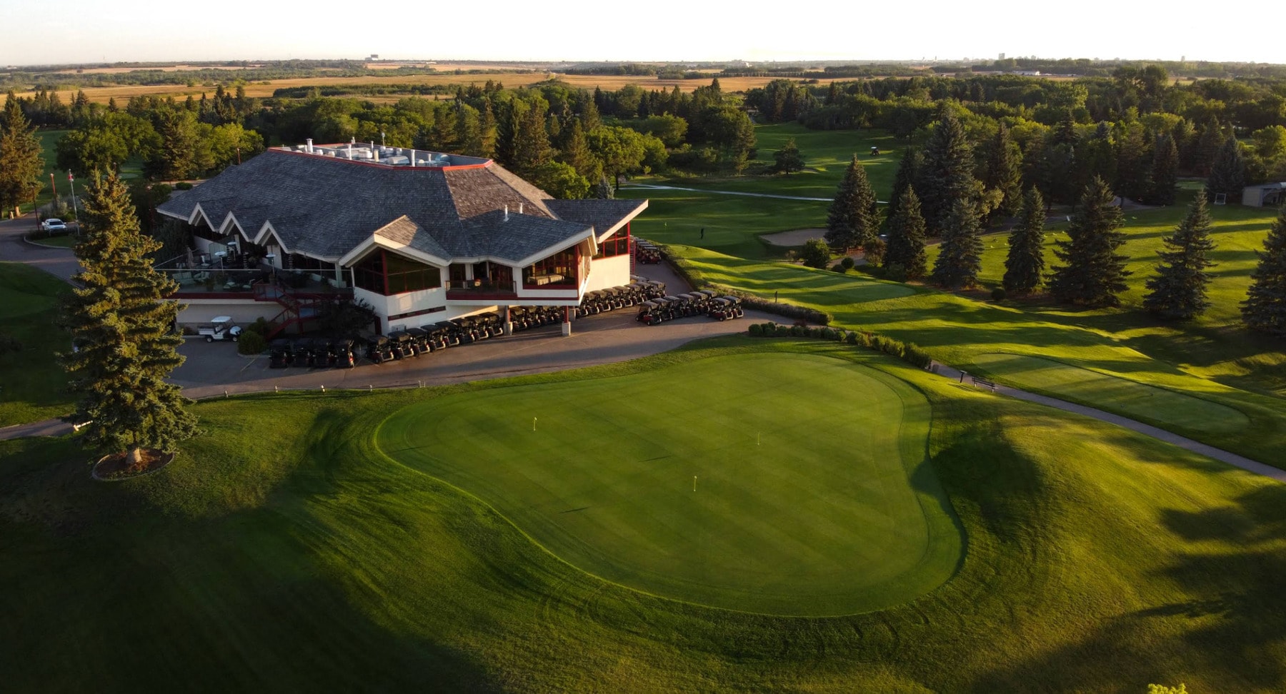 An aerial view of Riverside Country Club in Saskatoon, where manicured greens meet the scenic South Saskatchewan River valley. An aerial view of Riverside Country Club in Saskatoon, where manicured greens meet the scenic South Saskatchewan River valley.