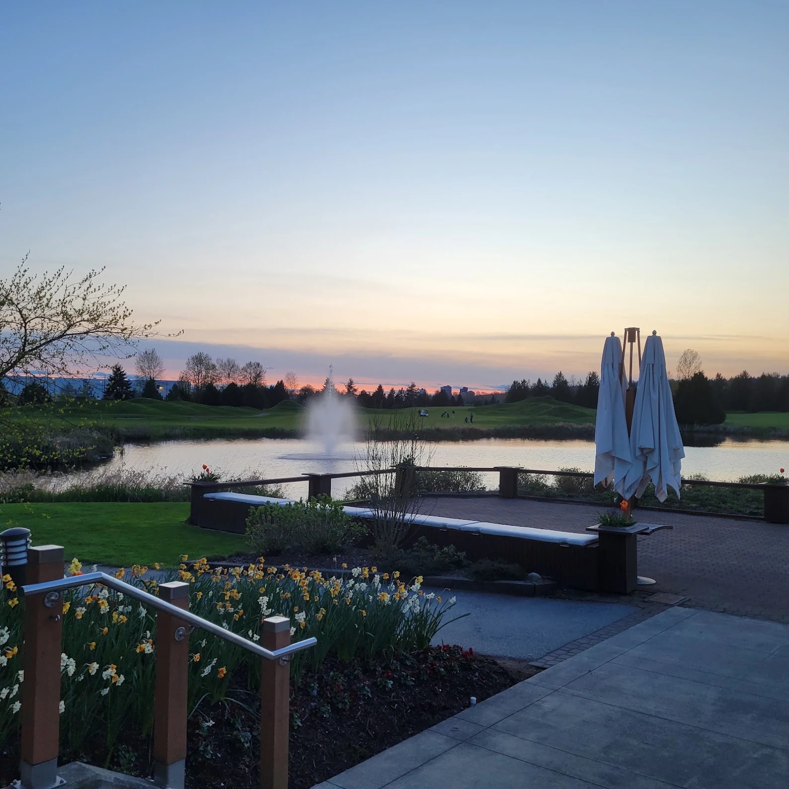 Evening glow at Riverway Golf Course with spring blooms, fountain, and fairways in view - just steps from the clubhouse patio. Evening glow at Riverway Golf Course with spring blooms, fountain, and fairways in view - just steps from the clubhouse patio.