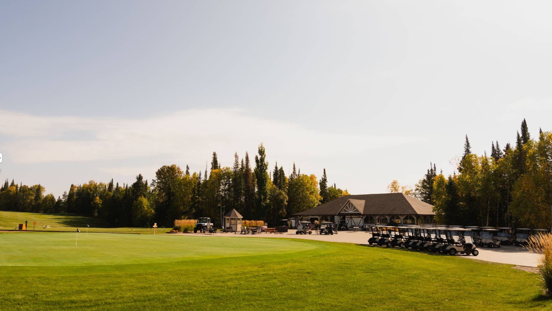 Morning sunshine over the clubhouse and practice green at Elk Ridge Resort, surrounded by the forests of northern Saskatchewan. Morning sunshine over the clubhouse and practice green at Elk Ridge Resort, surrounded by the forests of northern Saskatchewan.