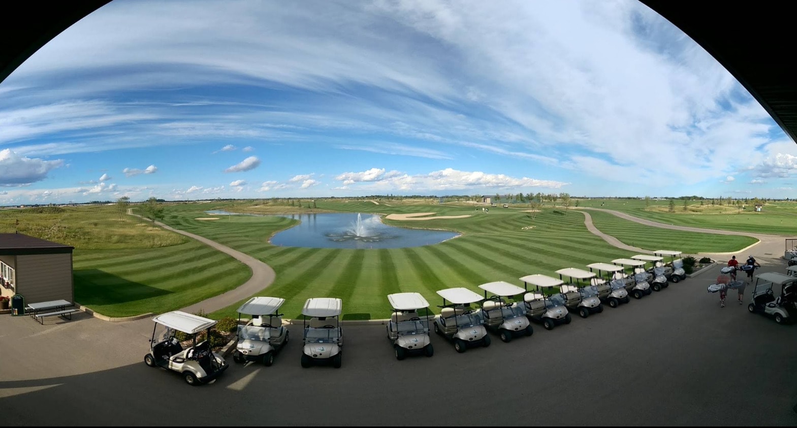 Panoramic views of The Legends Golf Club in Warman, where pristine fairways and a central fountain highlight the modern prairie landscape. Panoramic views of The Legends Golf Club in Warman, where pristine fairways and a central fountain highlight the modern prairie landscape.