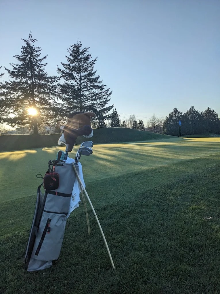 Sunrise shadows stretch across the green at Riverway, with a quiet morning bag waiting for first tee-off Sunrise shadows stretch across the green at Riverway, with a quiet morning bag waiting for first tee-off
