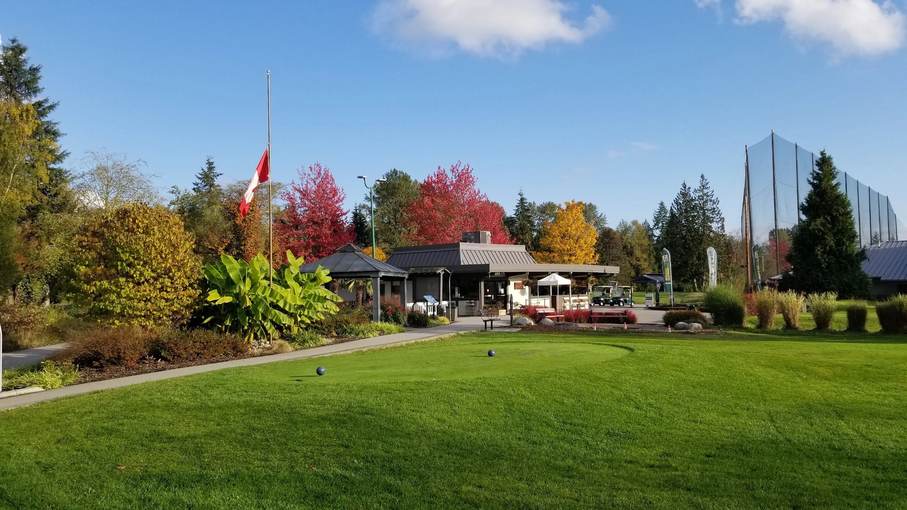 Vibrant fall colors frame the clubhouse and tee box at Burnaby Mountain - a stunning seasonal backdrop for your round. Vibrant fall colors frame the clubhouse and tee box at Burnaby Mountain - a stunning seasonal backdrop for your round.